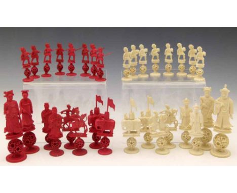 Chinese export red and white ivory figural chess set, 19th century, each of three sections with a puzzle ball stem, king heig