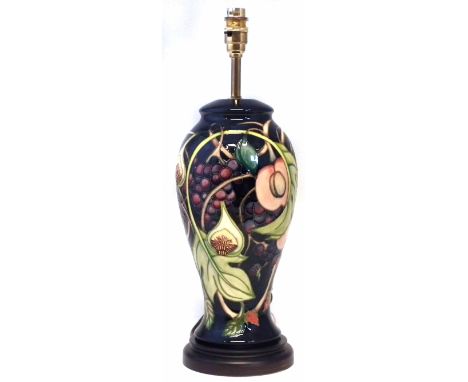 Moorcroft lamp base, decorated with Queen's Choice pattern, fitted with wood base, the ceramic part measures 31cm high     Co