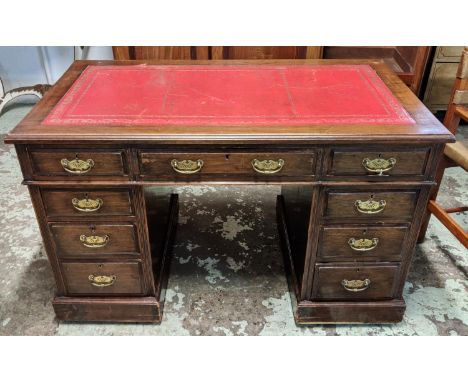 PEDESTAL DESK, 122cm x 76cm H x 67.5cm, late 19th century walnut with a red leather top above nine drawers. 