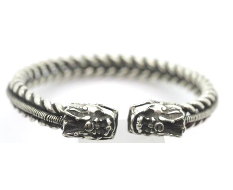 White metal Tibetan silver twisted rope effect bangle with dragon finials. P&amp;P Group 1 (£14+VAT for the first lot and £1+