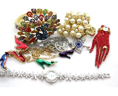 Butler and Wilson unboxed jewellery, including a large peacock bangle, two pendant necklaces, two bracelets, a diamonte watch