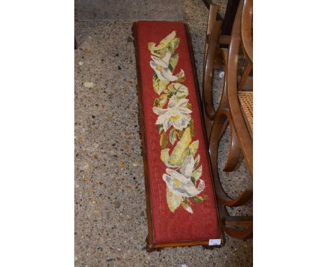 A low narrow rectangular cabriole legged stool with floral tapestry top
