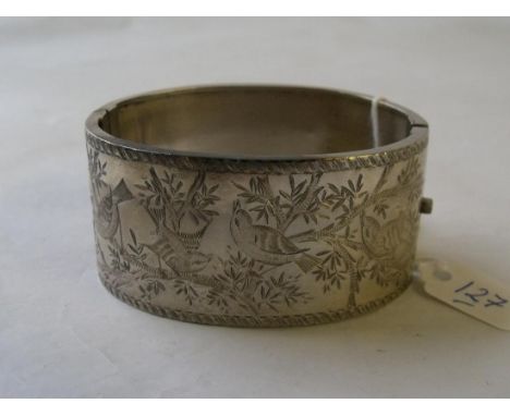 A plain & engraved silver bangle     