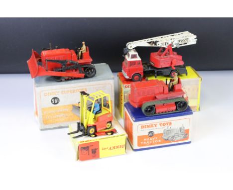 Four boxed Dinky diecast models to include 561 Blaw Knox Bulldozer in red, 563 Heavy Tractor, 404 Conveyancer Fork Lift Truck