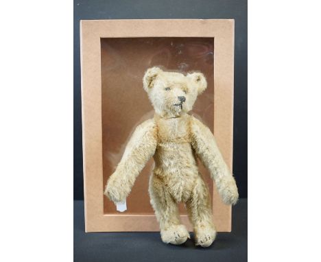 Early 20th C Steiff bear with light golden fur, straw filled, Steiff button to left ear, some wear and thinning to fur, 20cm 