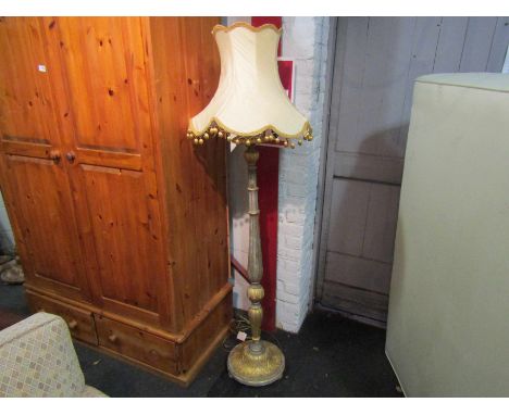 A classical gilded wood standard lamp with tasselled shade 