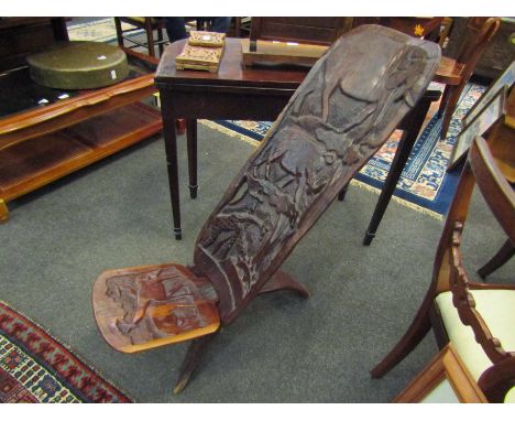 An African hardwood tree trunk chair carved with various African animals    