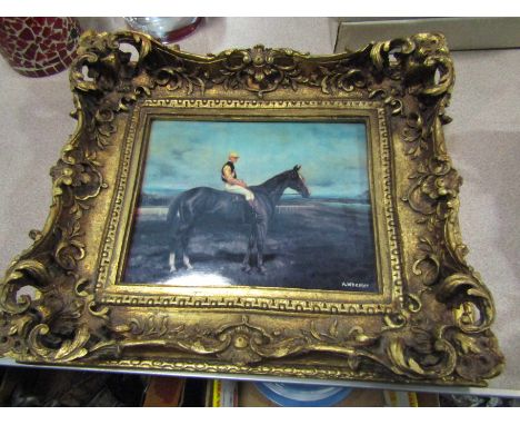 A. WHEELER: An ornately gilt framed oleograph depicting jockey on race horse, on ceramic plaque marked Vienna to reverse, sig