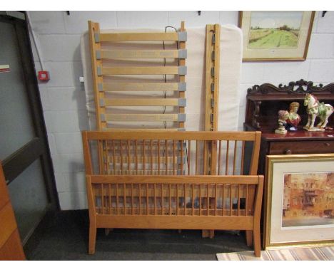 A solid light oak double bed with memory foam mattress