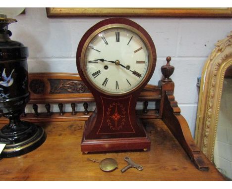 A Victorian mahogany inlaid balloon form striking mantel clock, with pendulum and key, 40cm tall