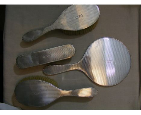 A  good quality 1960s hallmarked Silver Dressing  Table Set, in a stylised deco design, comprising  three brushes and a hand 