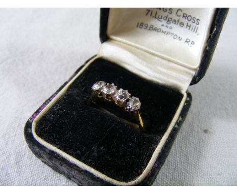 A high carat yellow metal Ring, line-set with four  good quality Diamonds each approx 3mm dia.