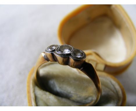 An 18ct Yellow Metal Ring, set with three line-set  Diamonds in a white metal settting, stamped "18CT  & PL".