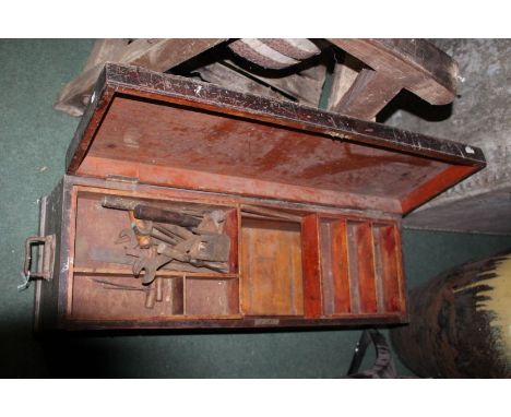 Stained wooden carpenters tool chest, containing a small amount of tools