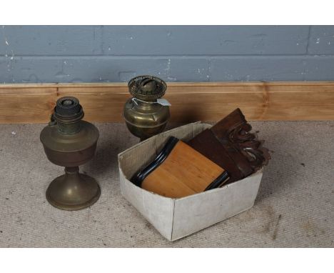 Two brass oil lamps, a crumb scoop with ebonised rim and a mahogany acanthus decorated shelf (4)