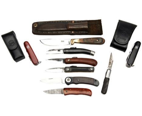 A VICTORINOX SWISS ARMY KNIFE another with compass and torch, an unmarked folding pocket knife with Damascus blade and three 