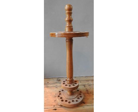A 20TH CENTURY WOODEN CIRCULAR WALKING STICK STAND with two concentric sets of holes 87 cm high