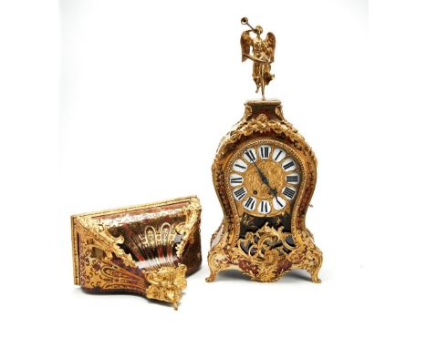 REGENCE STYLE BOULLE CLOCK 19TH CENTURY The domed top surmounted by a figure of a trumpeting angel, the balloon shaped case a