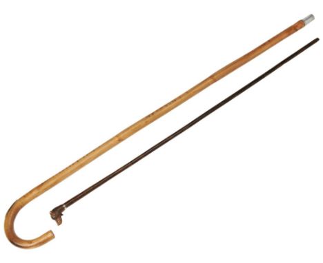 A WALKING STICK  with a knop carved in the form of a terriers head, with glass eyes and a white metal mount, early 20th centu