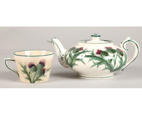 Wemyss ware teapot decorated with thistles with impressed and painted mark. height 9.5cm and a Wemyss ware cup. 