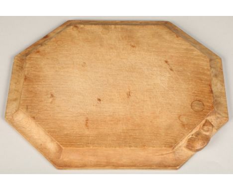 Robert Thompson of Kilburn, (1876-1955), a "Mouseman" carved oak breadboard,30.5cm x 25.5cm. 