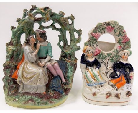 Victorian Staffordshire pottery group modelled as lovers under a tree arch, height 9.5in; together with a Staffordshire potte