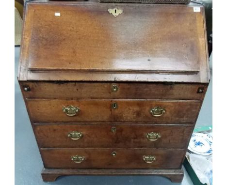 18th Century oak bureau, the fall front enclosing five pigeon holes and an arrangement of ten drawers over three graduated dr