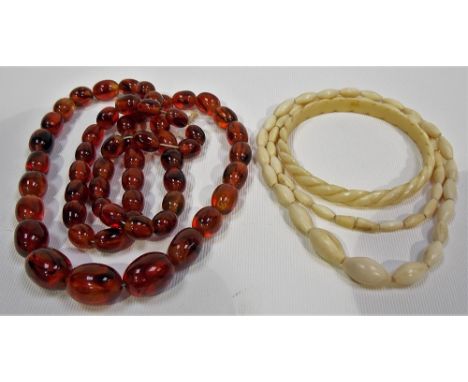 Early 20th Century ivory graduated oval bead necklace , together with an early 20th Century carved ivory twist bangle and amb