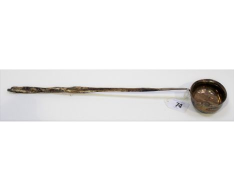 18th Century white metal toddy ladle with twisted handle, the plain oval bowl set with a Charles III Spanish small coin (hand