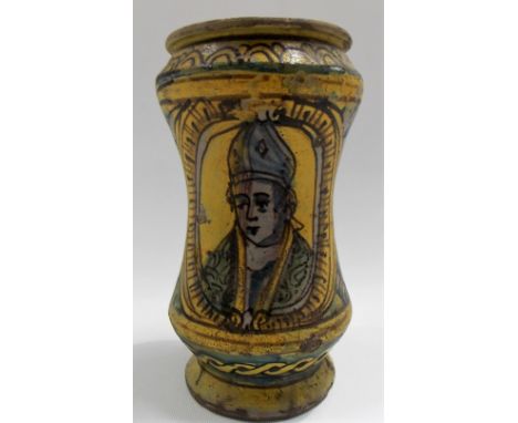 An antique majolica albarello painted in yellow and with blue, green and brown underglaze decorated to one side with the head
