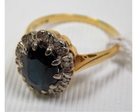 18ct gold diamond and sapphire cluster ring, the dark oval cut sapphire surrounded by chip diamonds, weight 4.3g approx