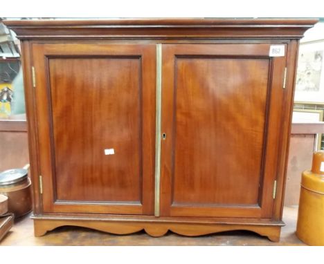 Edwardian table cabinet with pair of hinge doors over a shaped apron and bracket feet, width 26in