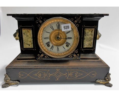 Black painted metal and simulated marble two train mantel clock, width 14in.