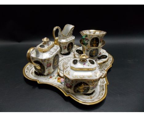 19th Century porcelain cabaret set for two, foliate spray painted with gilt highlights & with four black gilded foliate reser