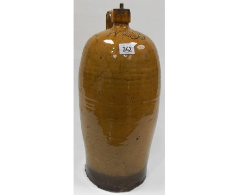 19th Century slipware large storage bottle, possibly North Devon with light brown glaze, the shoulder of the bottle monogramm