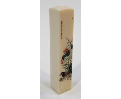 Japanese Meiji period rectangular section ivory desk seal engraved and stained in green, red and black to one side with a wat