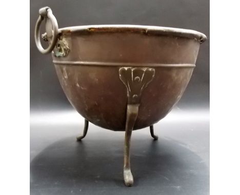 Arts and Crafts copper ovoid twin ring handled planter raised on three feet, diameter 30in.