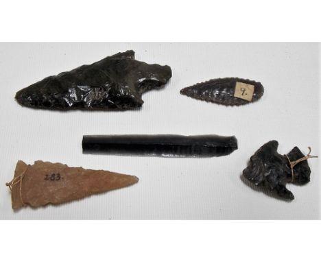 Three Obsidian arrow heads together with a fine leaf shaped blade and a stone arrow head