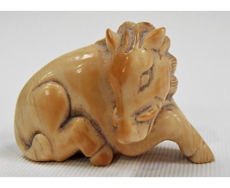 19th Century Japanese ivory Netsuke carved as a reclining boar, width 2in.