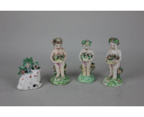 Three 19th century porcelain figures of cherubs holding baskets of flowers tallest 12cm high, together with a porcelain model