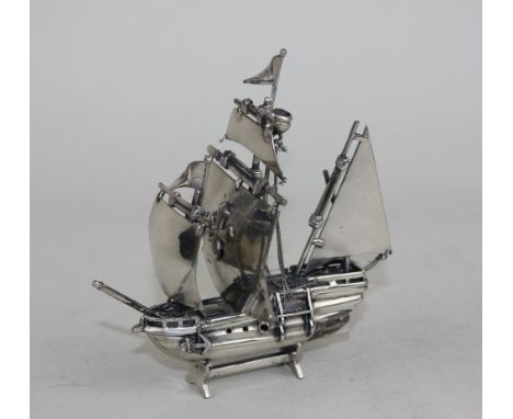 A white metal possibly Italian model of galleon with sails, flags, crowsnest and other details, 11cm