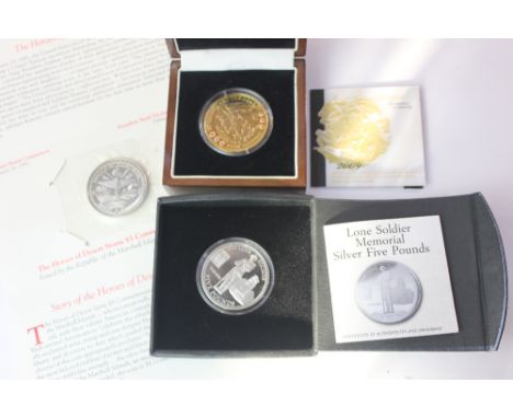 A 2009 St George &amp; Dragon gold plated silver five pound coin with inset rubies and enamel, cased with paperwork, A 2014 T