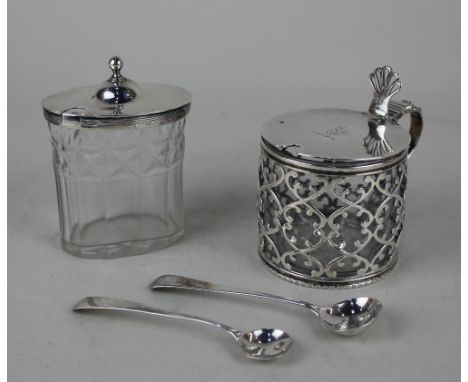 A George III silver lidded glass mustard pot oval facetted form with silver mount and domed lid and associated spoon, maker J