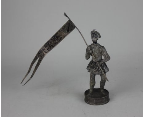 A Continental silver model of a soldier holding a flag 17.5cm high