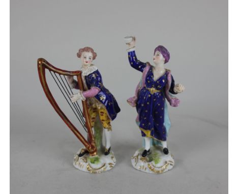 Two Derby porcelain figures, a musician playing a harp 14cm high, and a figure wearing a turban holding aloft a cup 14cm high