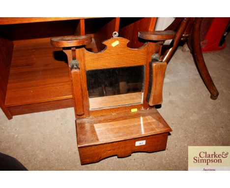 An early 20th Century oak mirrored wall shelf 