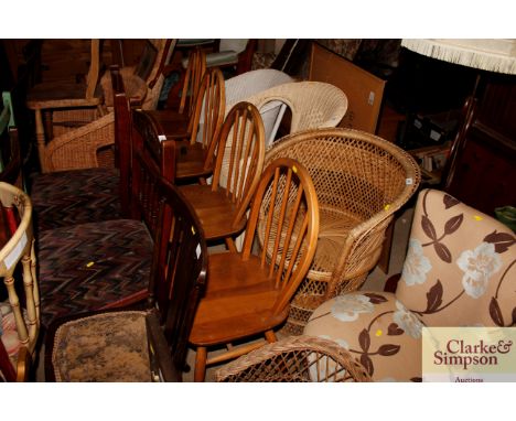 A set of four Ercol type elm seated stick back kitchen chairs 