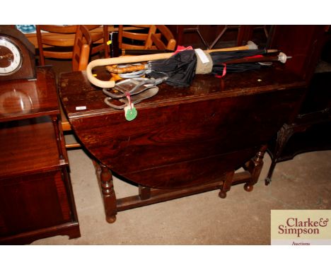 An antique oak gate leg table fitted single drawer 