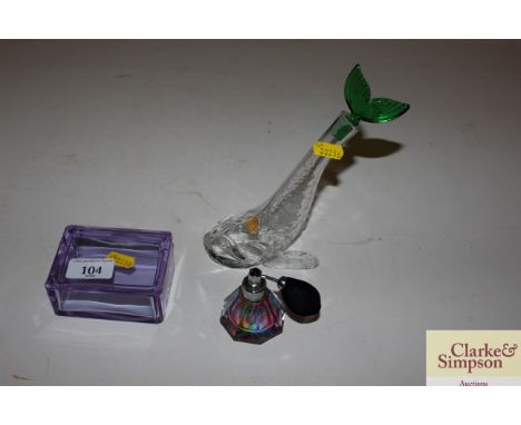 A mauve glass trinket box; a perfume atomiser and a glass dolphin scent bottle 