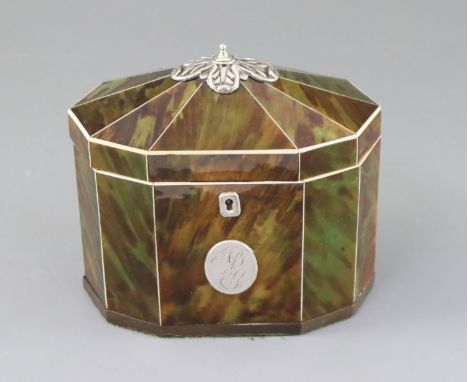 A George III silver mounted green stained tortoiseshell and ivory tea caddy, of decagonal form, with foliate finial, the inte